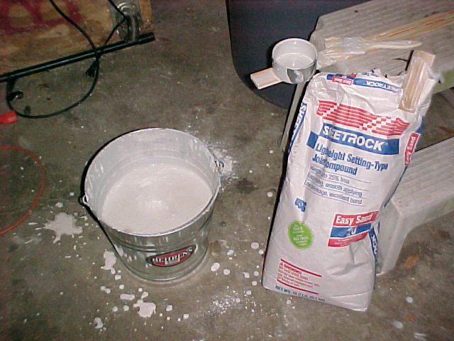 drywall mud mixed with water in a dipping bucket.jpg